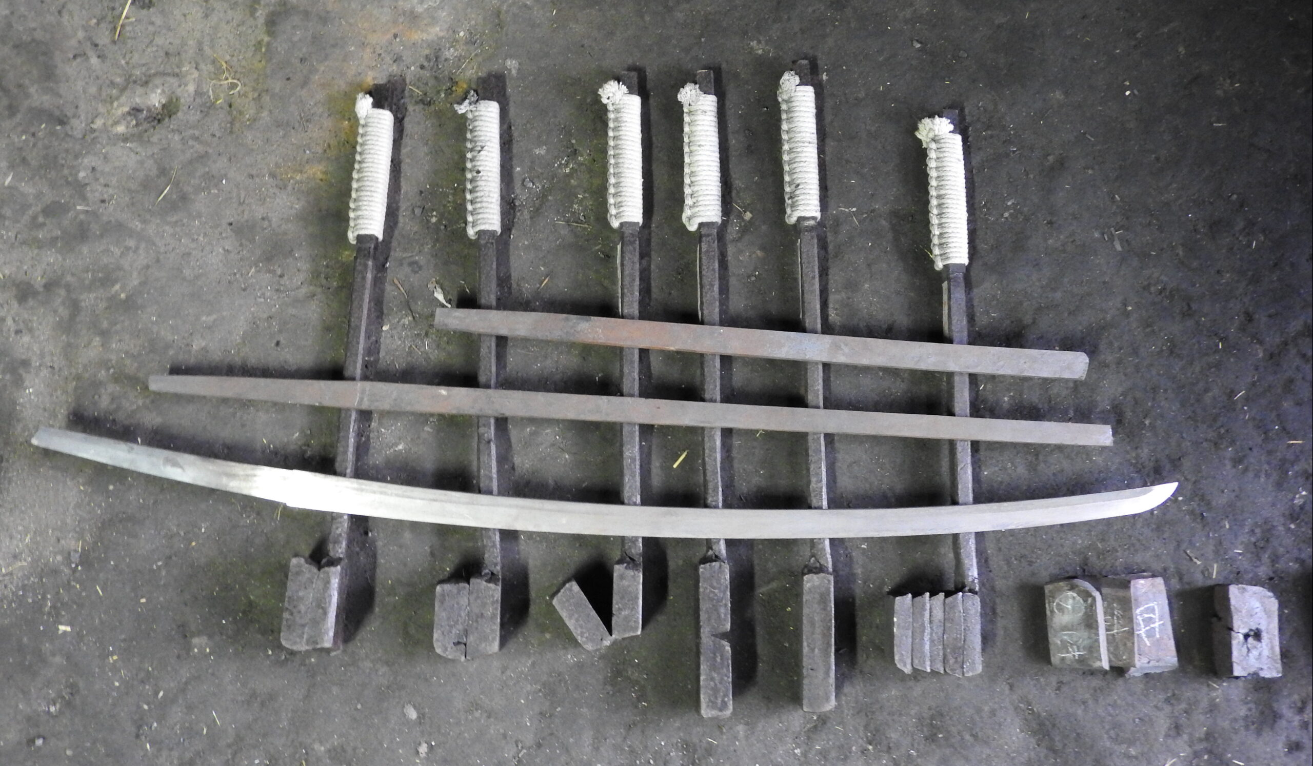 Stages of Japanese steel preparation — from raw ingot through forged blade