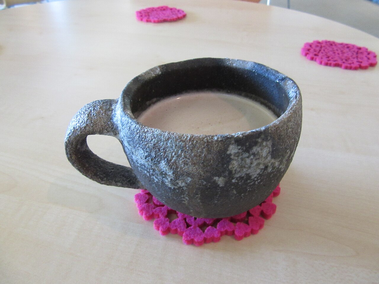 Echizen stoneware cup showing glassy green natural ash glaze and iron flush from anagama wood-firing