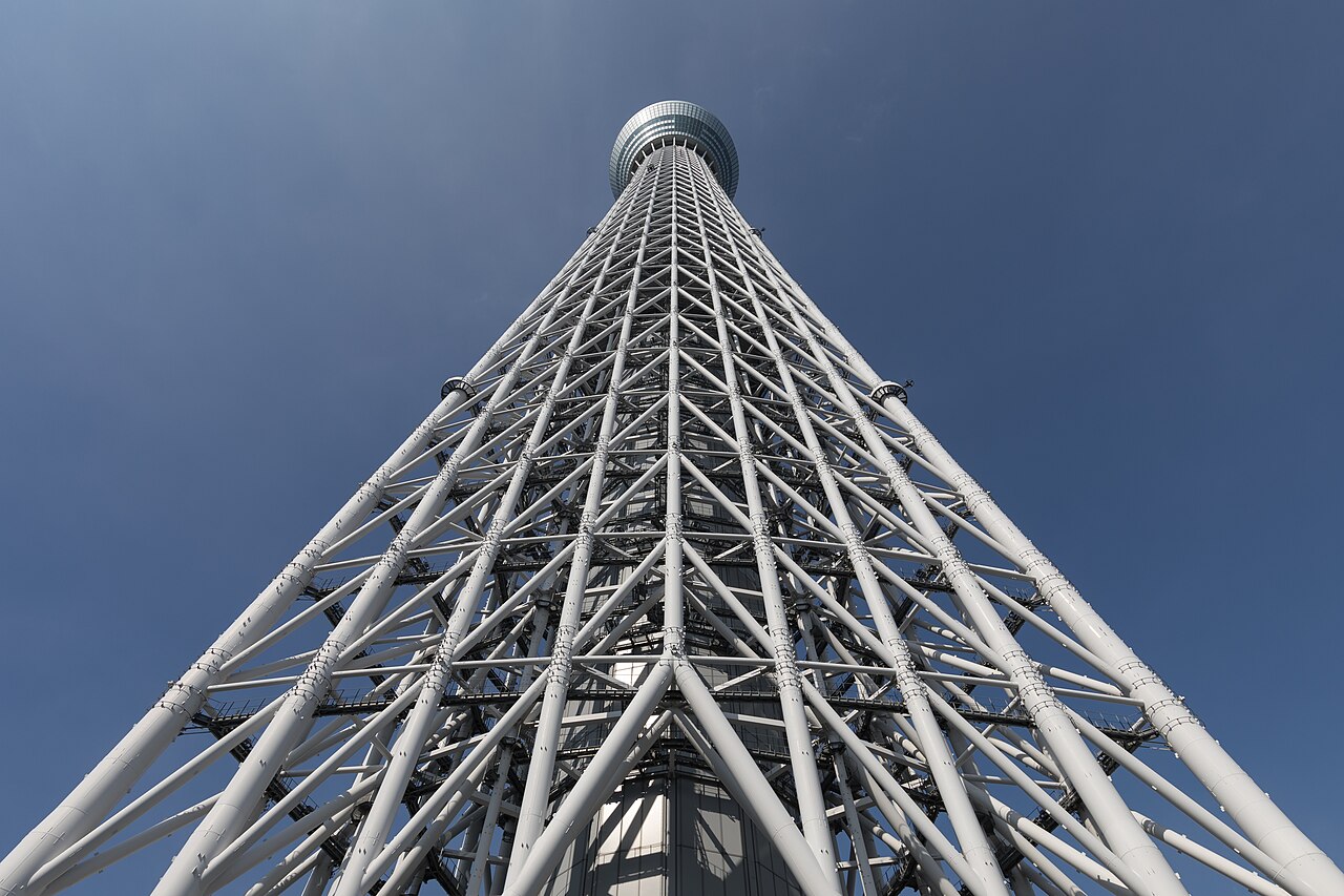 Worm's-eye view of Tokyo Skytree on a sunny day, rising above the eastern wards of Tokyo