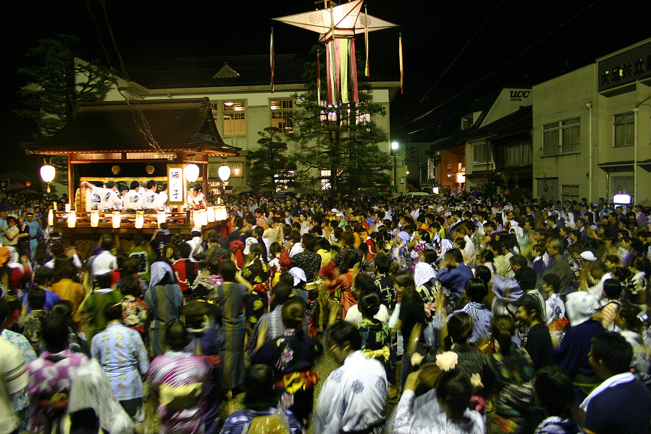 Crowds dancing in the streets at night during the Gujo Odori festival