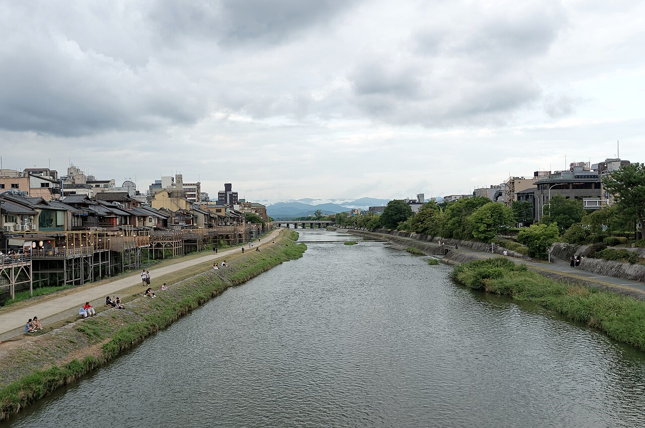 The Kamo River running through Kyoto, with people on its grassy banks