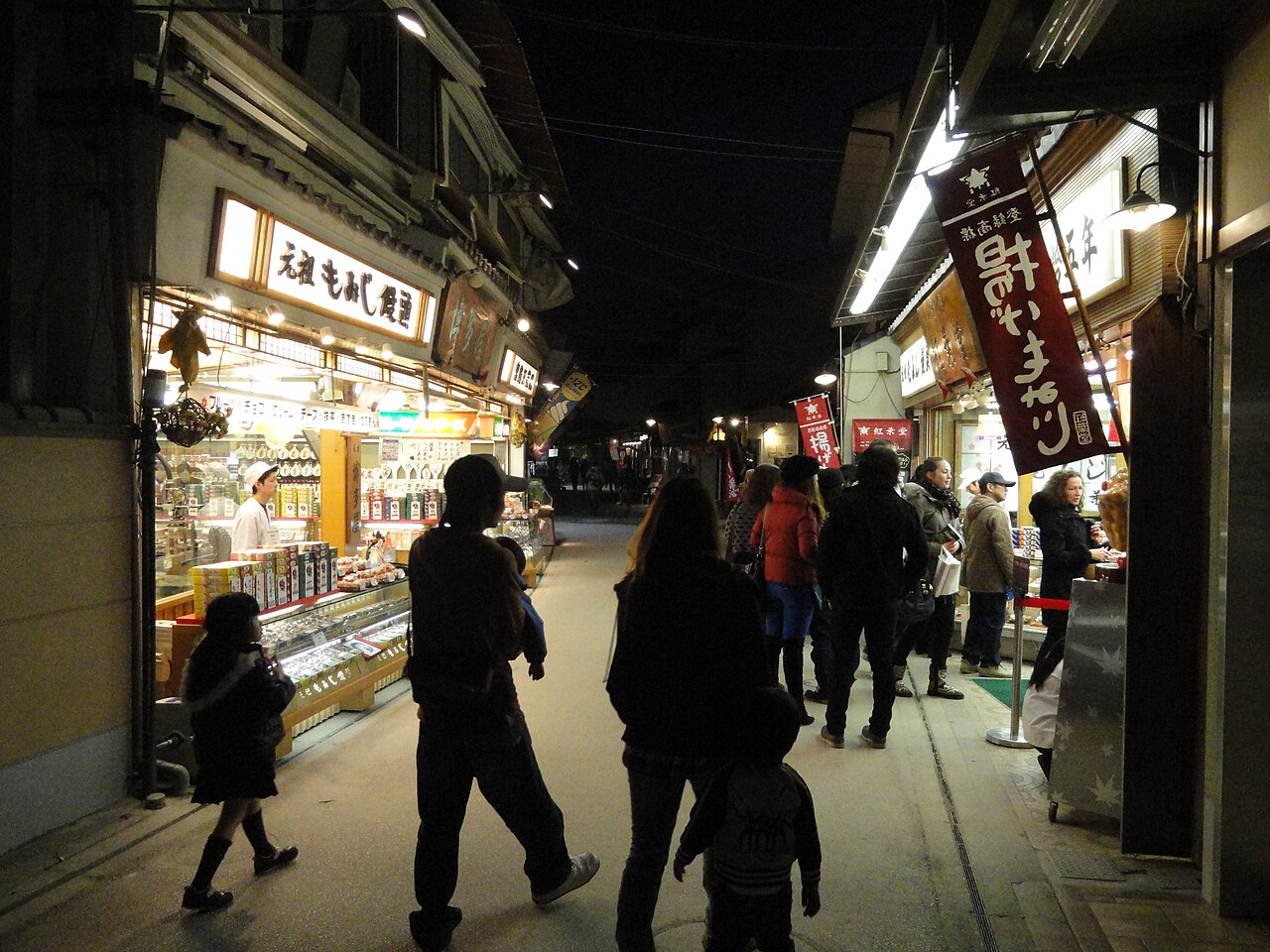 Evening shops along the Omotesando arcade on Miyajima, lined with souvenir and craft stores