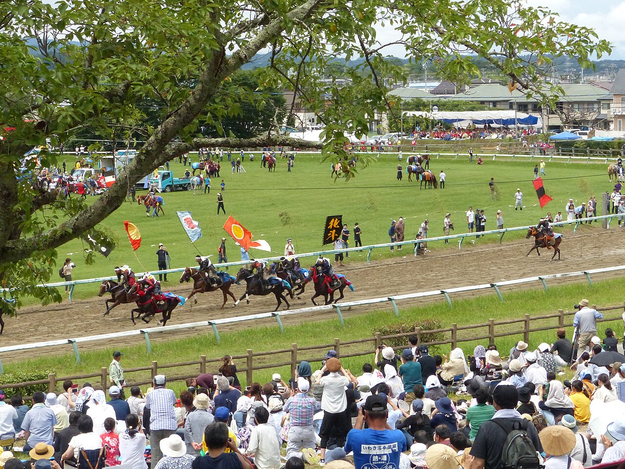 Armored riders galloping at the Soma Nomaoi wild-horse festival
