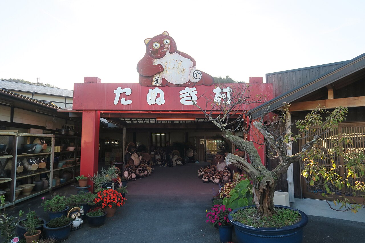 Rows of ceramic tanuki raccoon-dog figures lining a Shigaraki pottery street